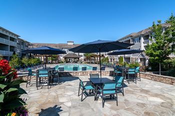 our apartments have a large patio with tables and chairs and a pool